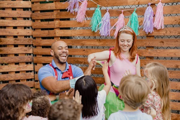 Children playing and laughing together with the caregivers.