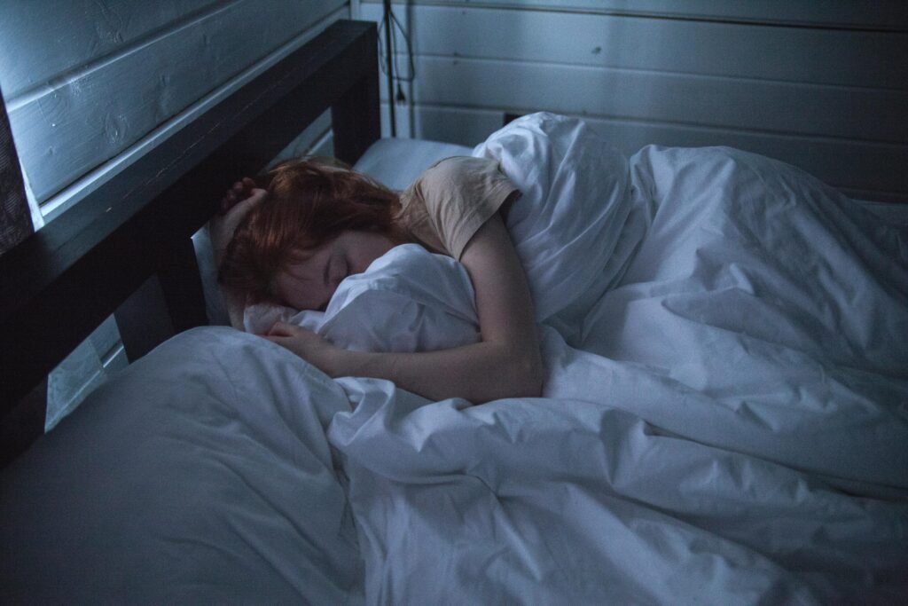 A person sleeping peacefully in bed.