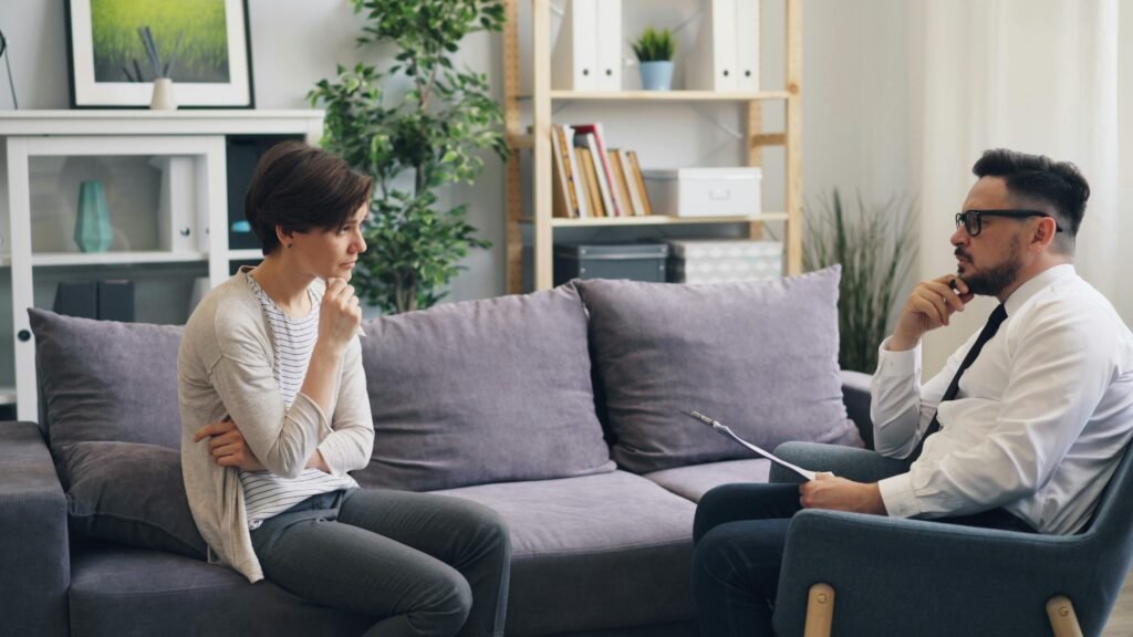 A manager and employee discussing work-related matters in a relaxed setting.